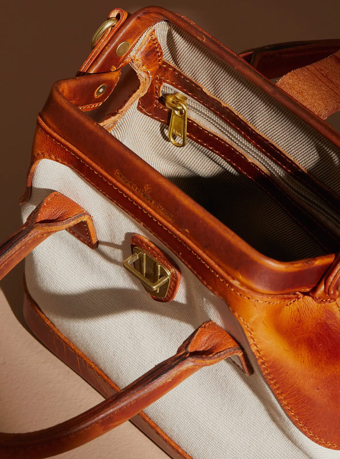 Blanco leather framed canvas Bag by Uppdoo